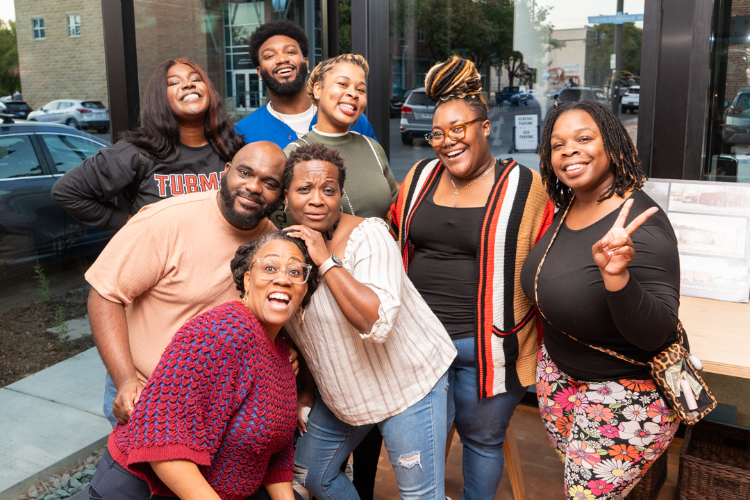 A group of theater performers poses for a photo during the theater dedication event