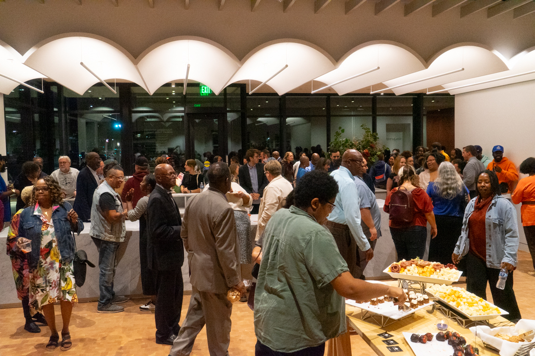 A large crowd mingles and fills the space during the theater dedication event