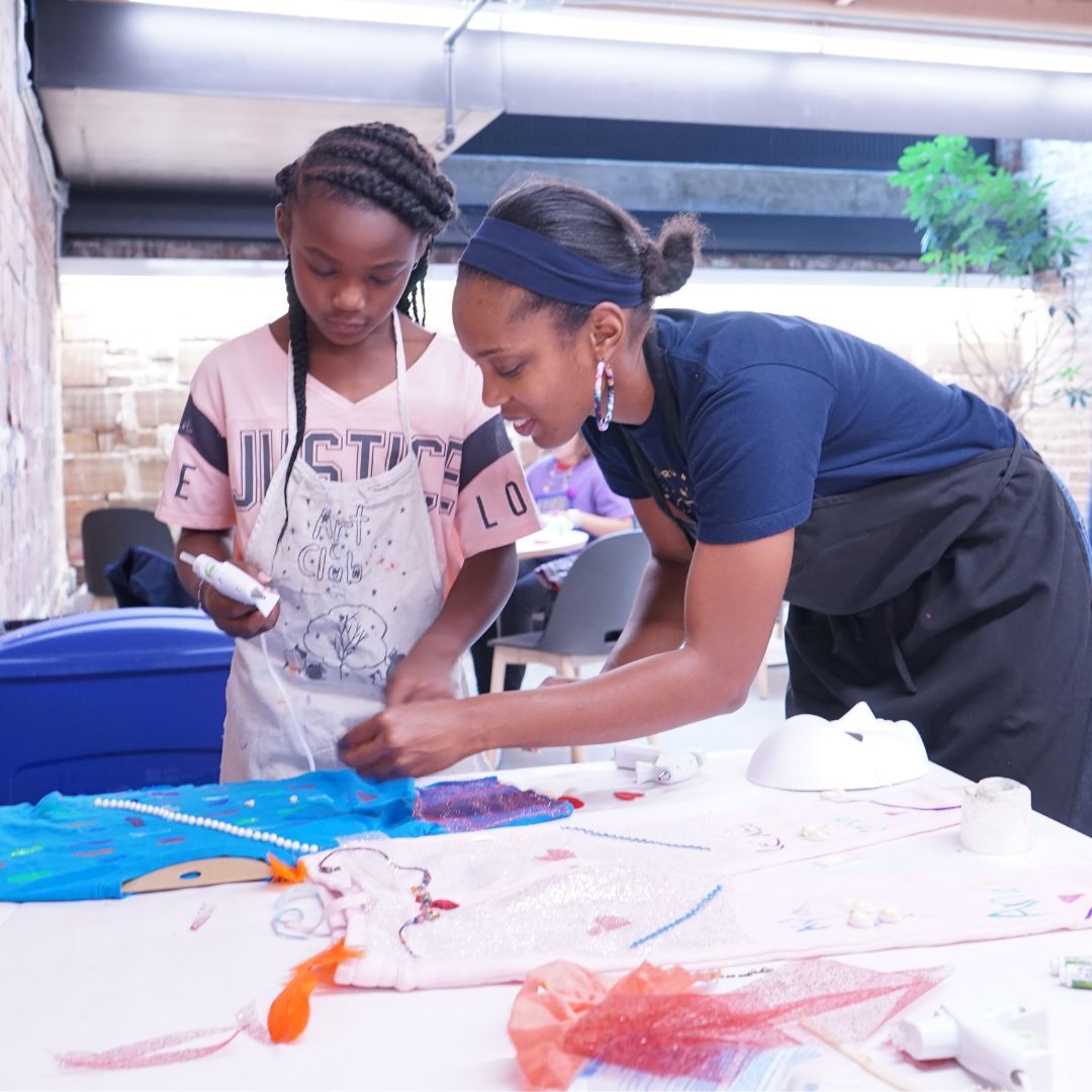 A young artist and her mother collaborate on a fabric collage during Family Night