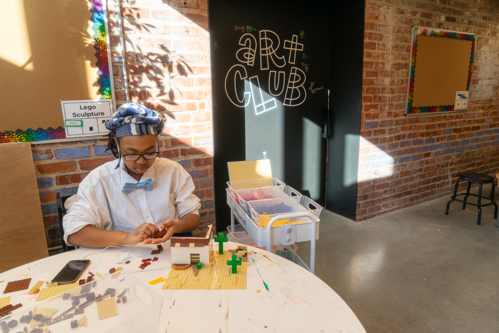 An Art Club artist works with legos in the Youth Studios
