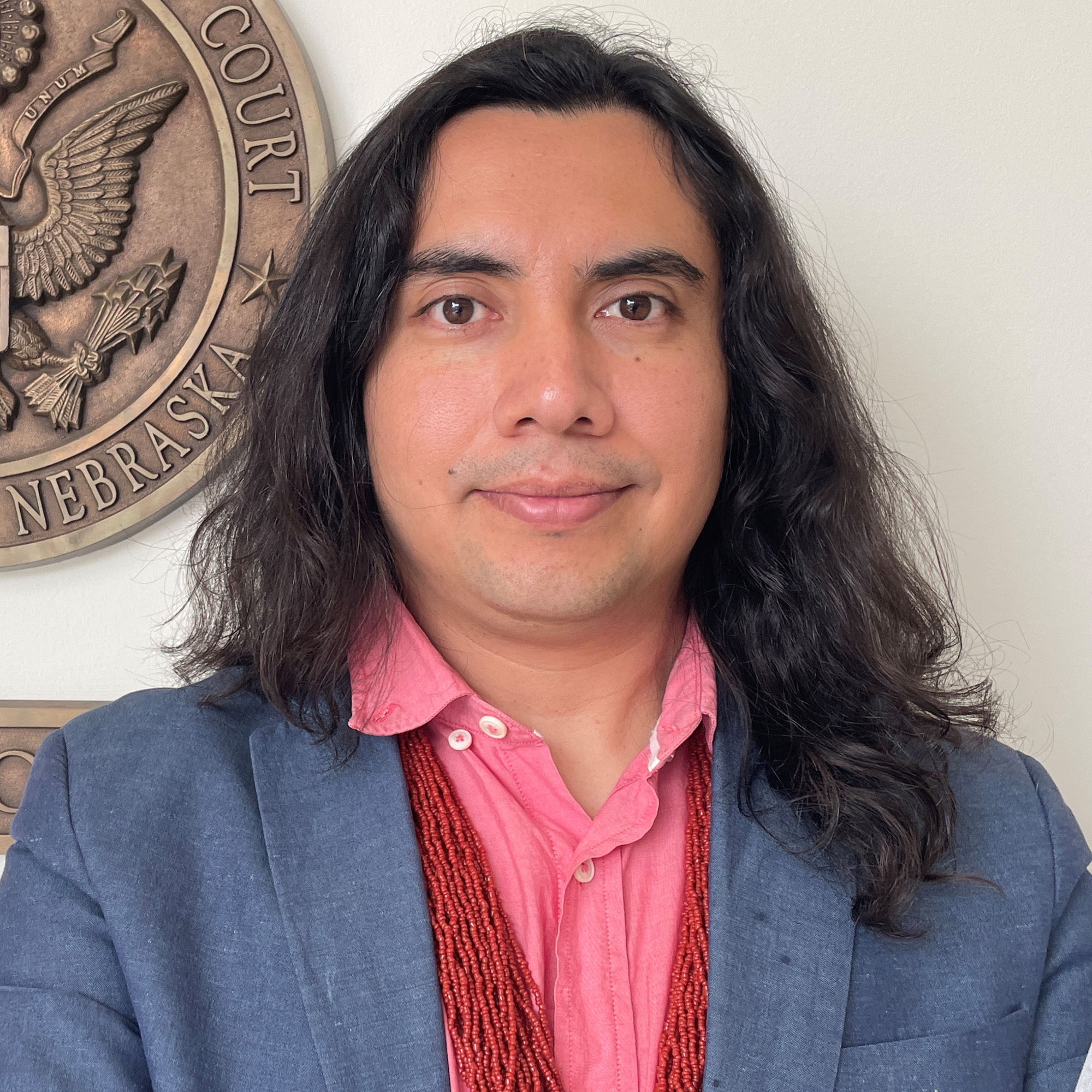 Artist David Manzanares Looks Into The Camera Wearing A Navy Blazer And A Pink Button Up Shirt