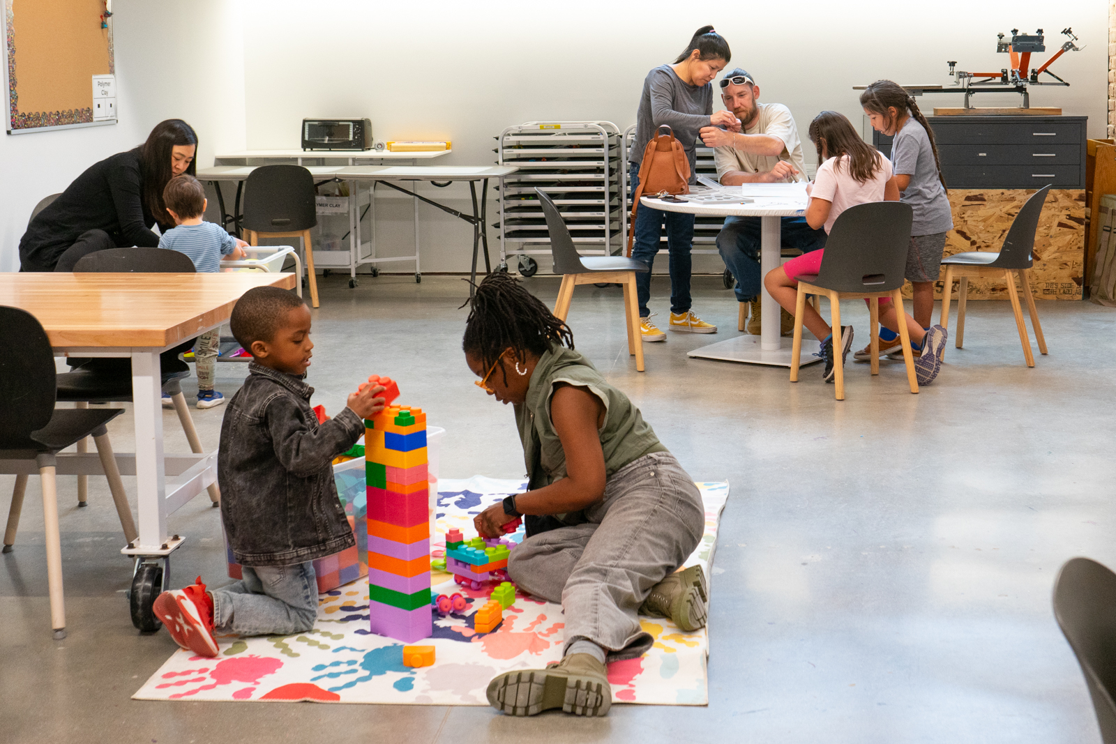 Families explore art stations at Family Night in the Youth Studios