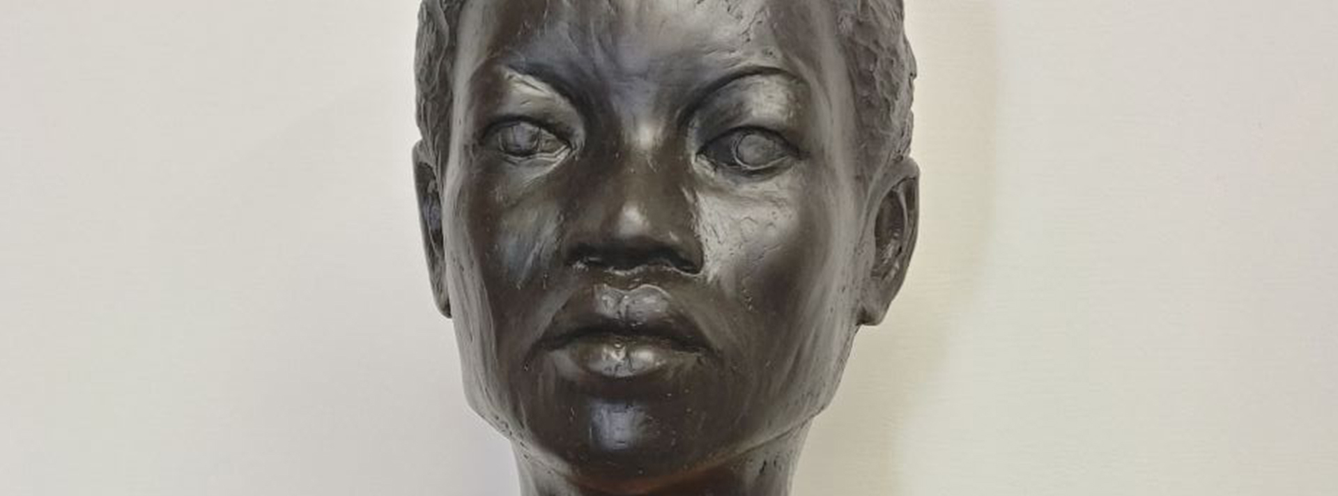 Header Pamela Conyers Hinson Project Black Is Beautiful Bronze Bust of a woman against a white background