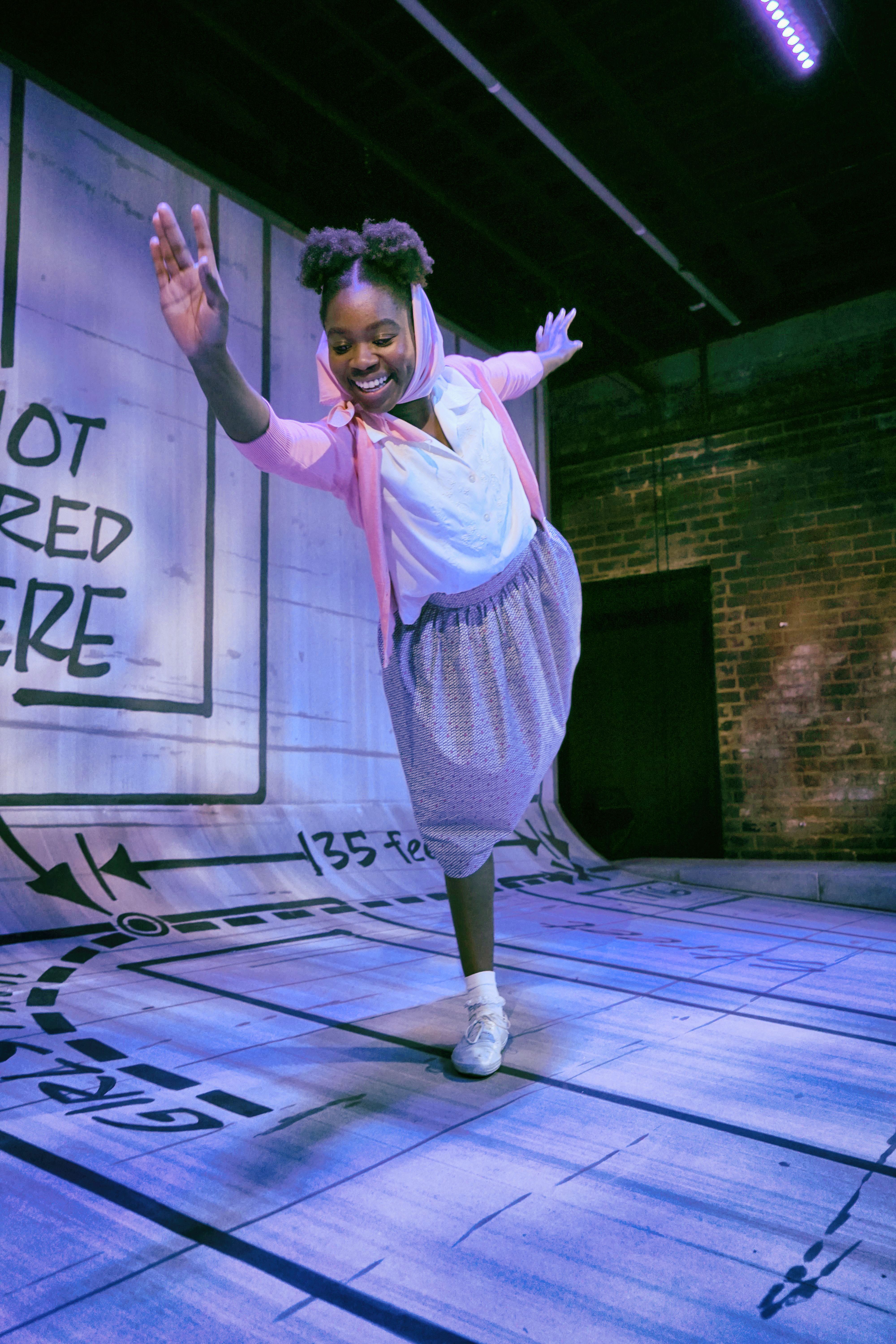 Photo of actress smiling on stage from the 2019 production The Blues of Knowing Why
