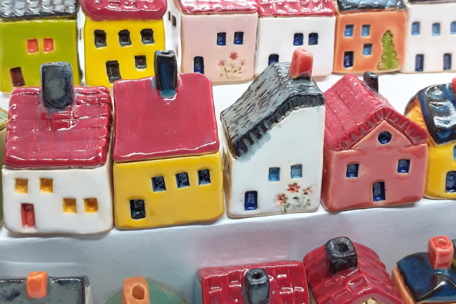 Rows Of Multicolor Ceramic Houses On A Tiered Display