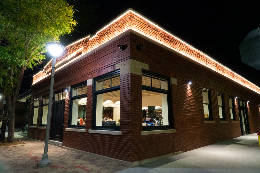 The exterior corner of the Shirley Tyree Theater as seen from 24th st and Willis Ave at night