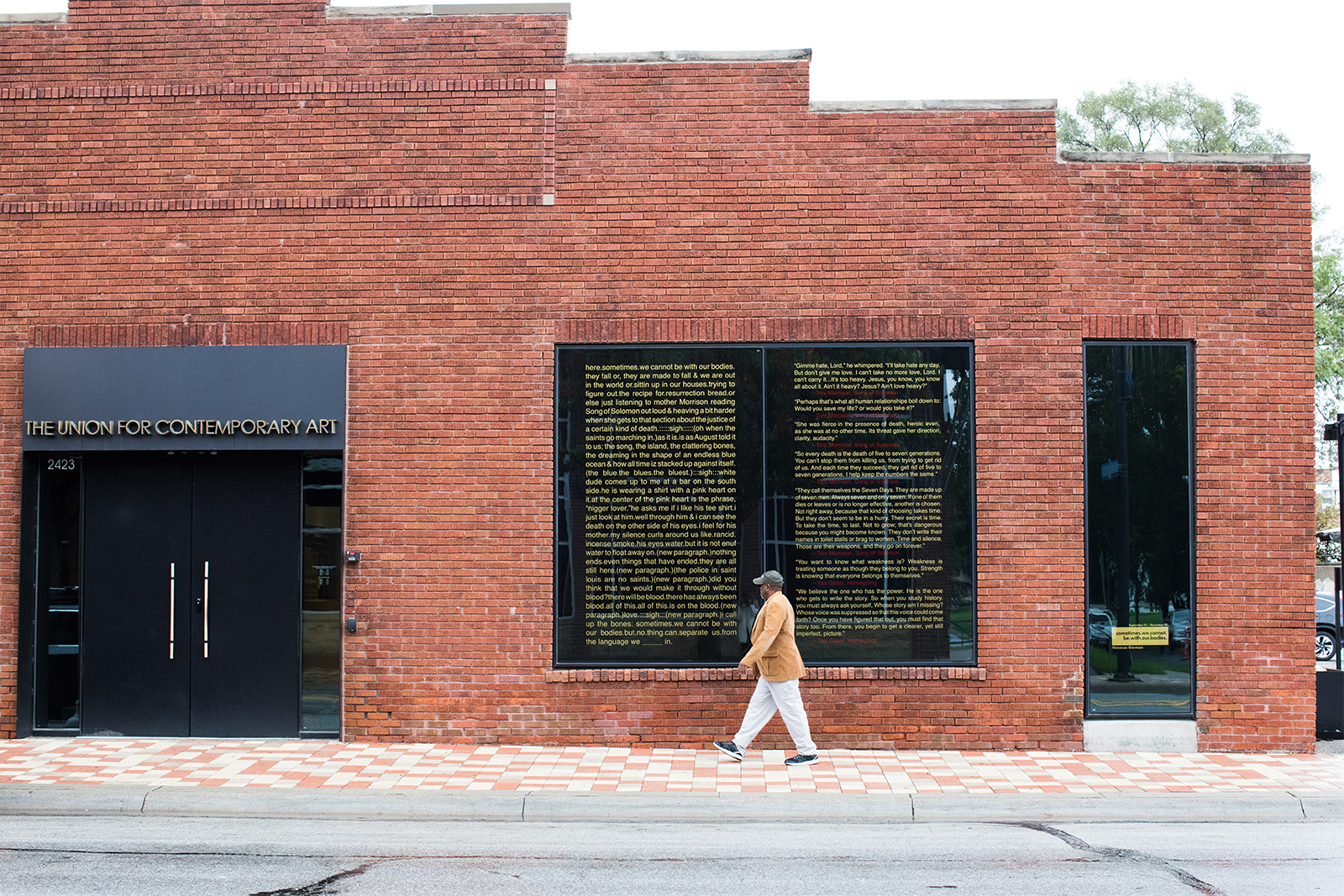 Vanessa German - Exterior of Union building with text written by Vanessa German filling one window frame and quotes from Toni Morrison and other filling the second window.