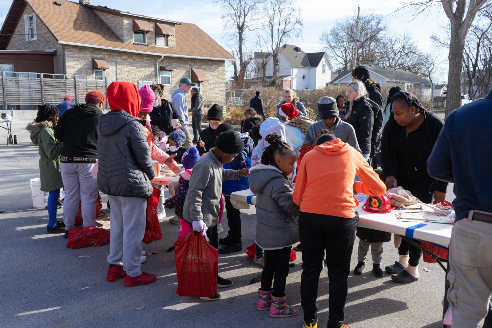 Youth decorate ceramic pieces for Raku firing during Christmas In The Village