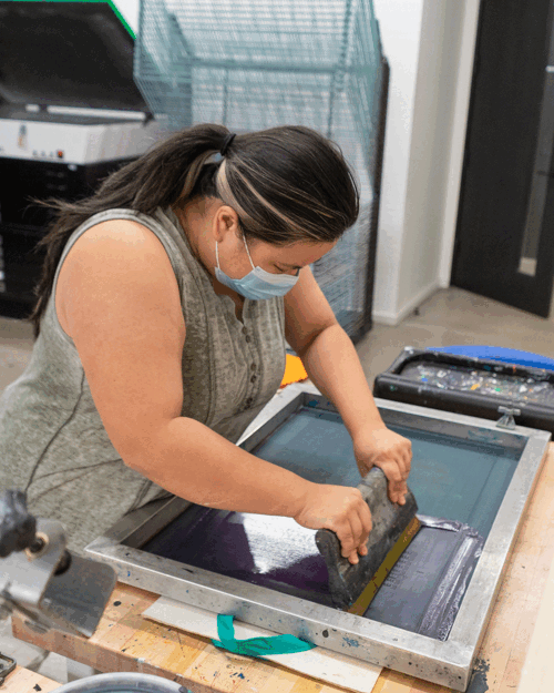 Animated GIF showing the print shop and people screen printing and french press wood block engraving