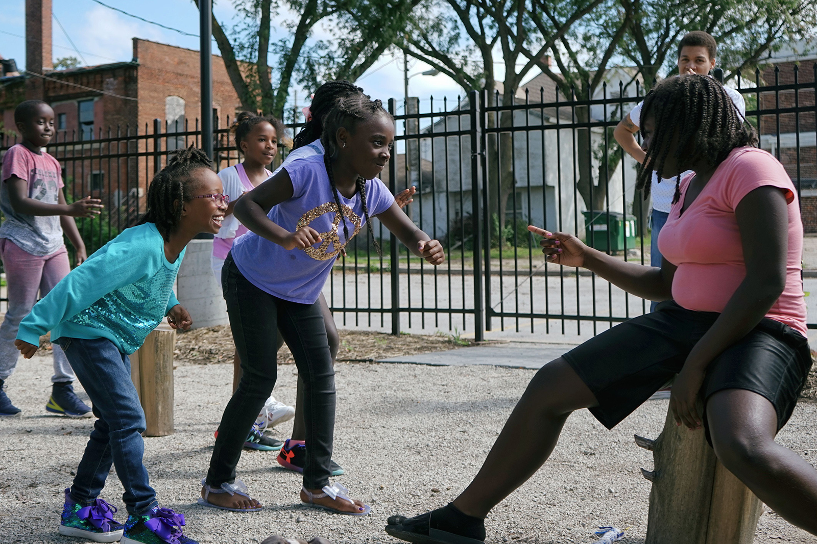 Three young girls play a game of Freeze in the Abundance Garden